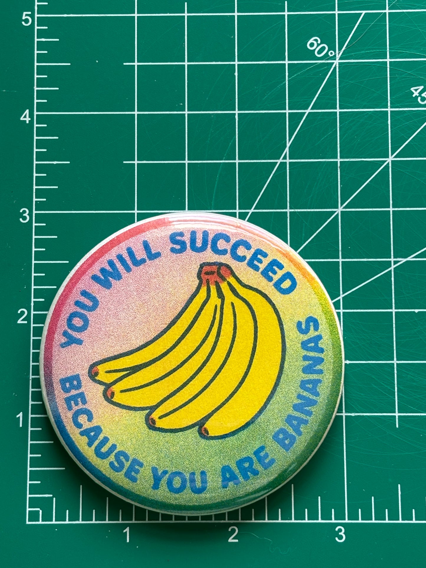 You will succeed because you are bananas. 3 inch Risograph style pin back button.